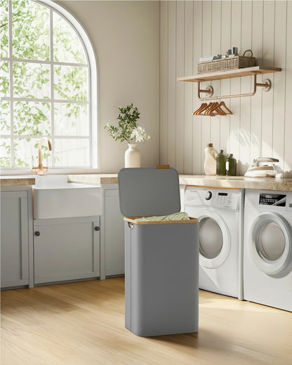 Tokari opvouwbare wasmand van 90 liter in grijs Oxford-stof met deksel in een lichte, moderne wasruimte.